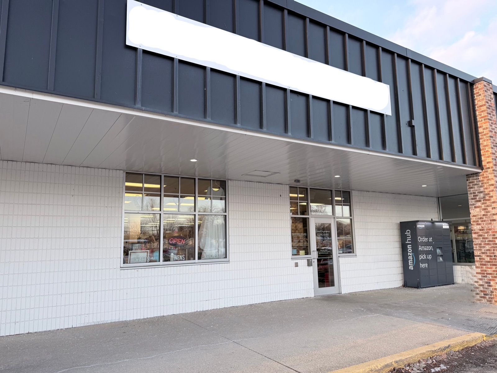 Available anchor commercial storefront for lease at Harbor View Plaza, 319–327 Winnebago Drive, Fond du Lac — blank signage panel ready for a new tenant